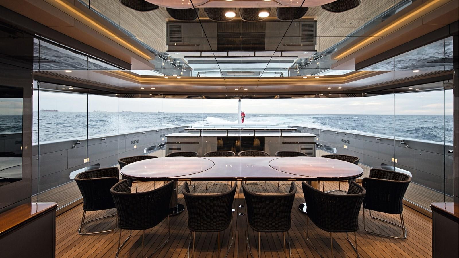 a room with a table and chairs aboard SILVER EDGE Yacht for Sale