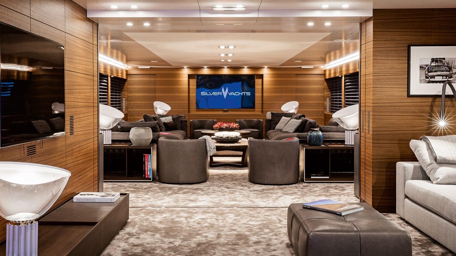 a large living room with a large screen aboard SILVER EDGE Yacht for Sale