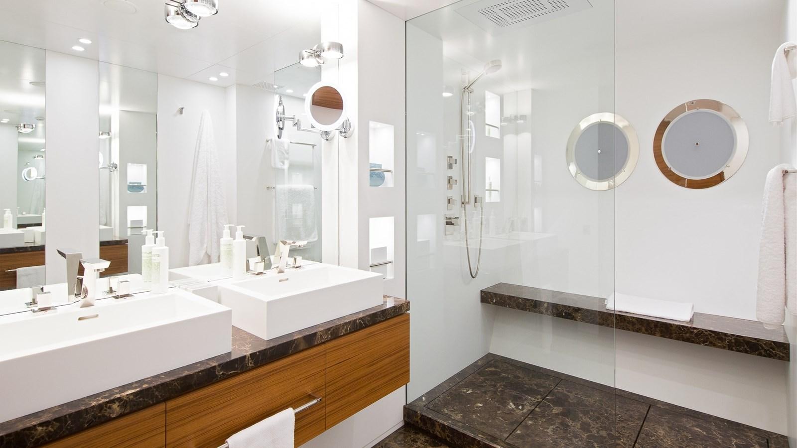 a bathroom with a large mirror aboard SILVER EDGE Yacht for Sale