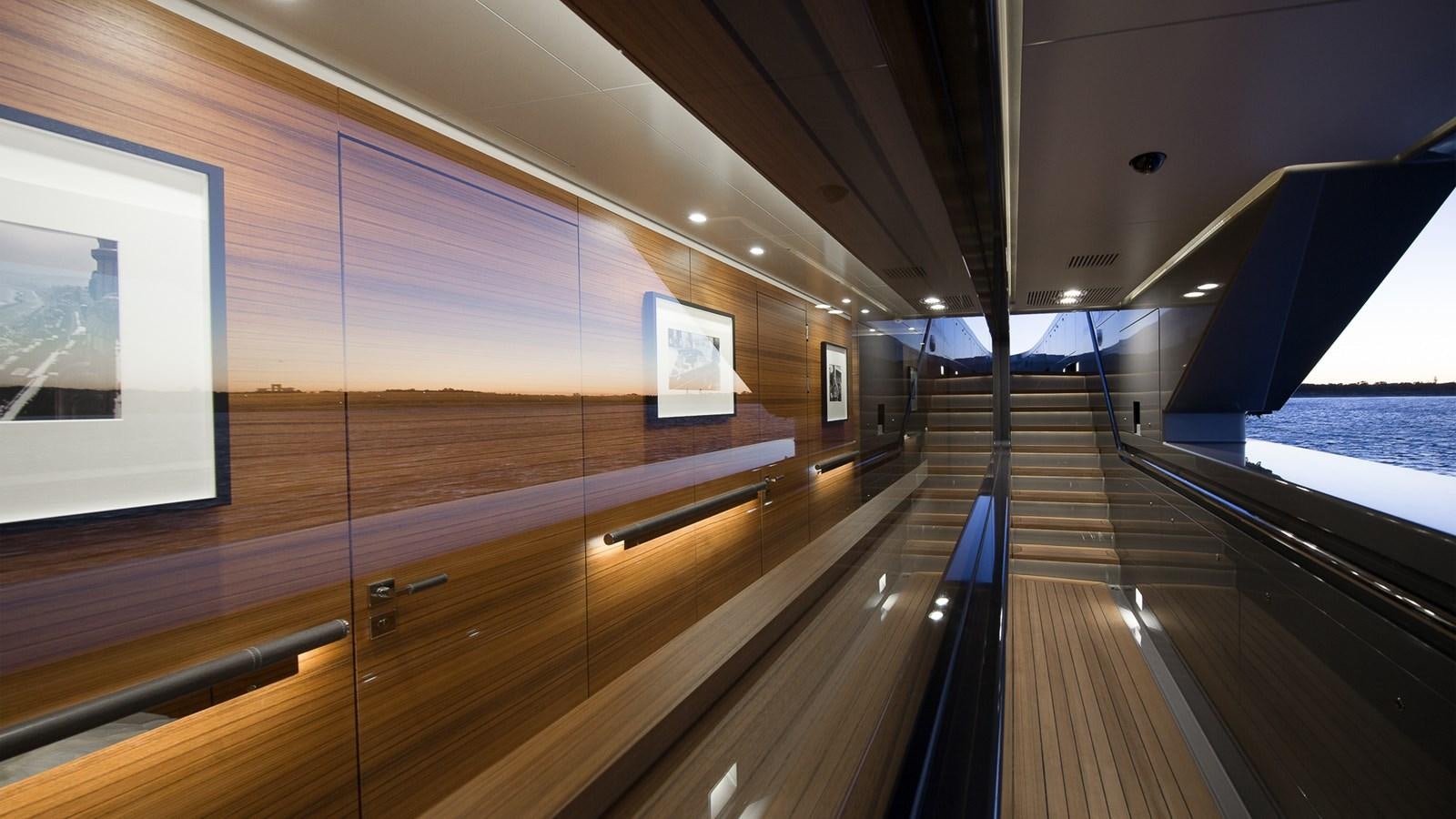 a wooden staircase with a glass wall aboard SILVER EDGE Yacht for Sale