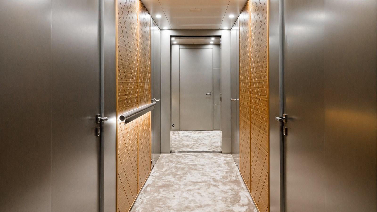 a hallway with doors aboard SILVER EDGE Yacht for Sale