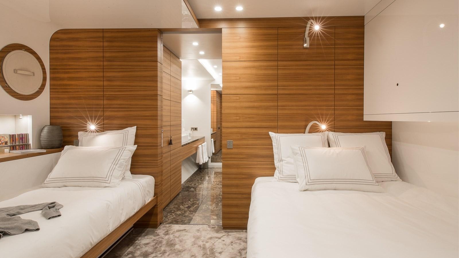 a room with a bed and a mirror aboard SILVER EDGE Yacht for Sale
