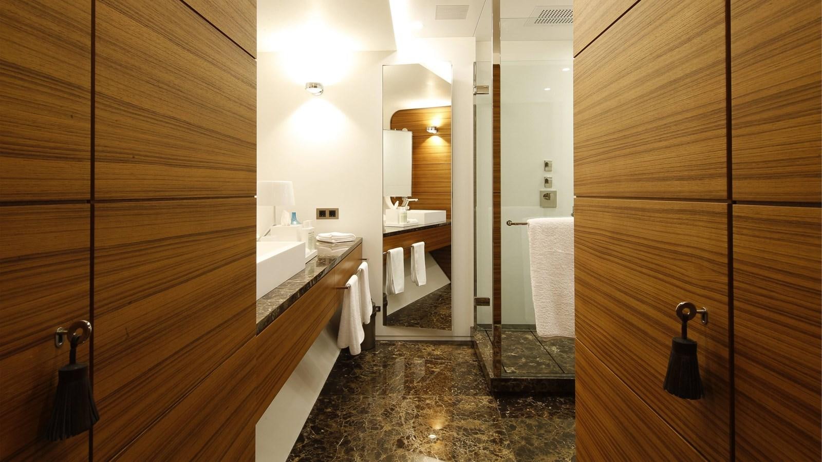 a bathroom with a large mirror aboard SILVER EDGE Yacht for Sale