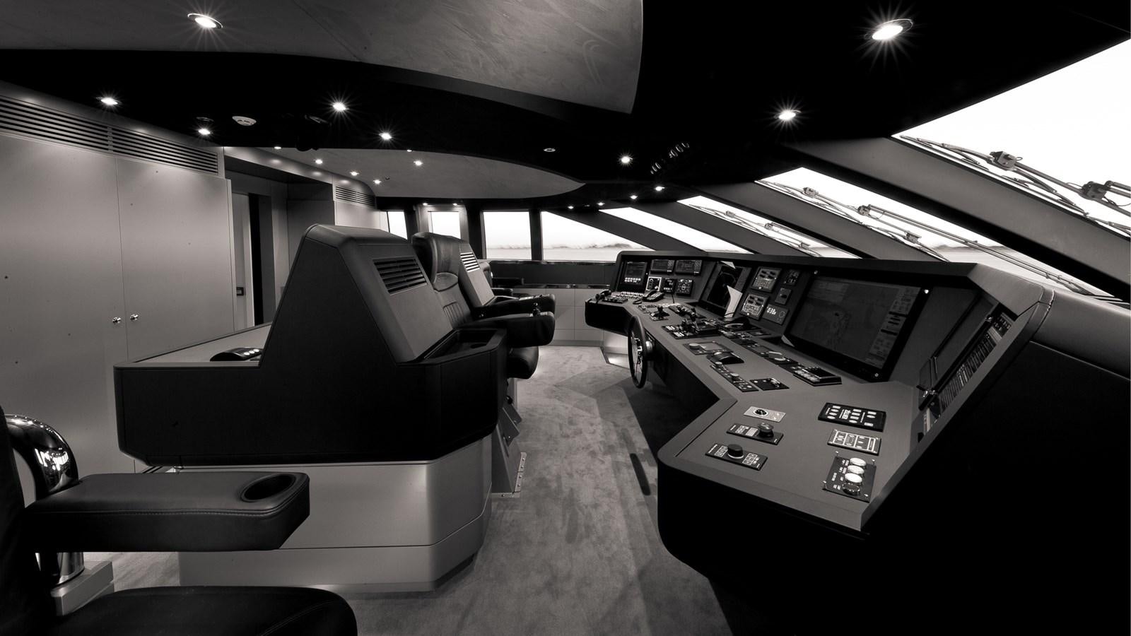 a black and white photo of a room with computers and chairs aboard SILVER EDGE Yacht for Sale
