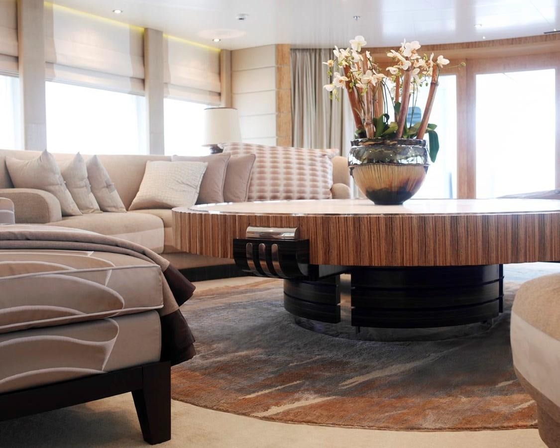 a living room with a large table and chairs aboard PREDATOR Yacht for Sale