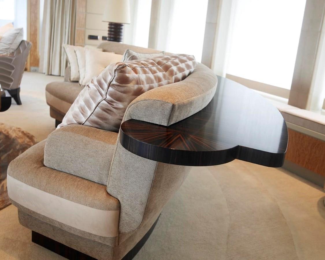 a living room with a couch and a coffee table aboard PREDATOR Yacht for Sale