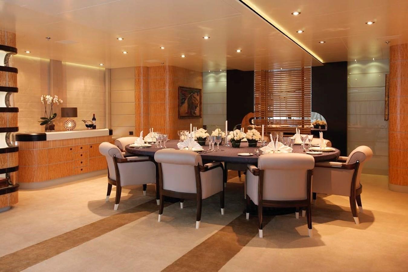 a large room with a table and chairs aboard PREDATOR Yacht for Sale