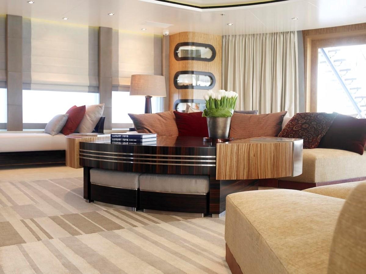 a living room with a leather couch aboard PREDATOR Yacht for Sale