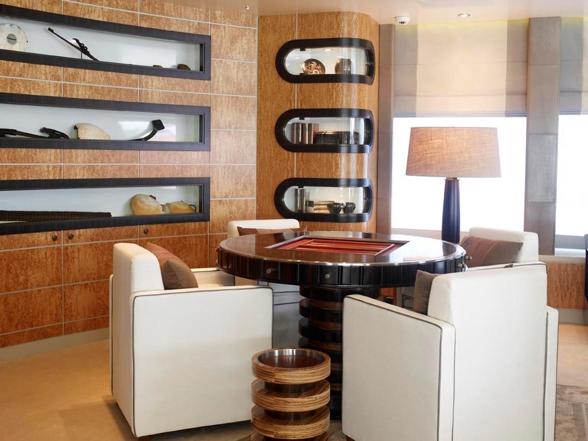 a room with a fireplace and a table aboard PREDATOR Yacht for Sale