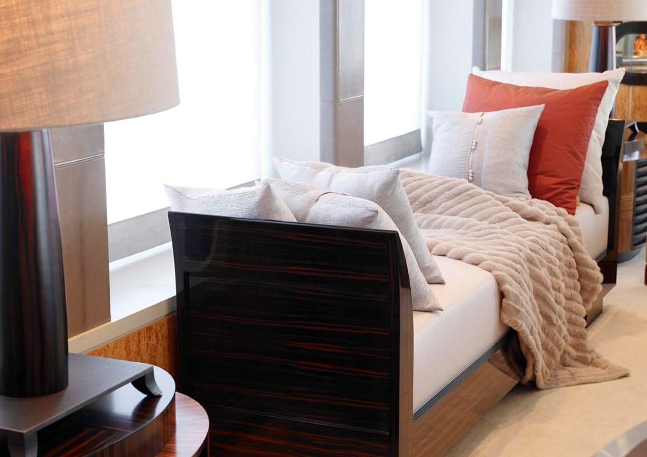 a bed with a white comforter aboard PREDATOR Yacht for Sale