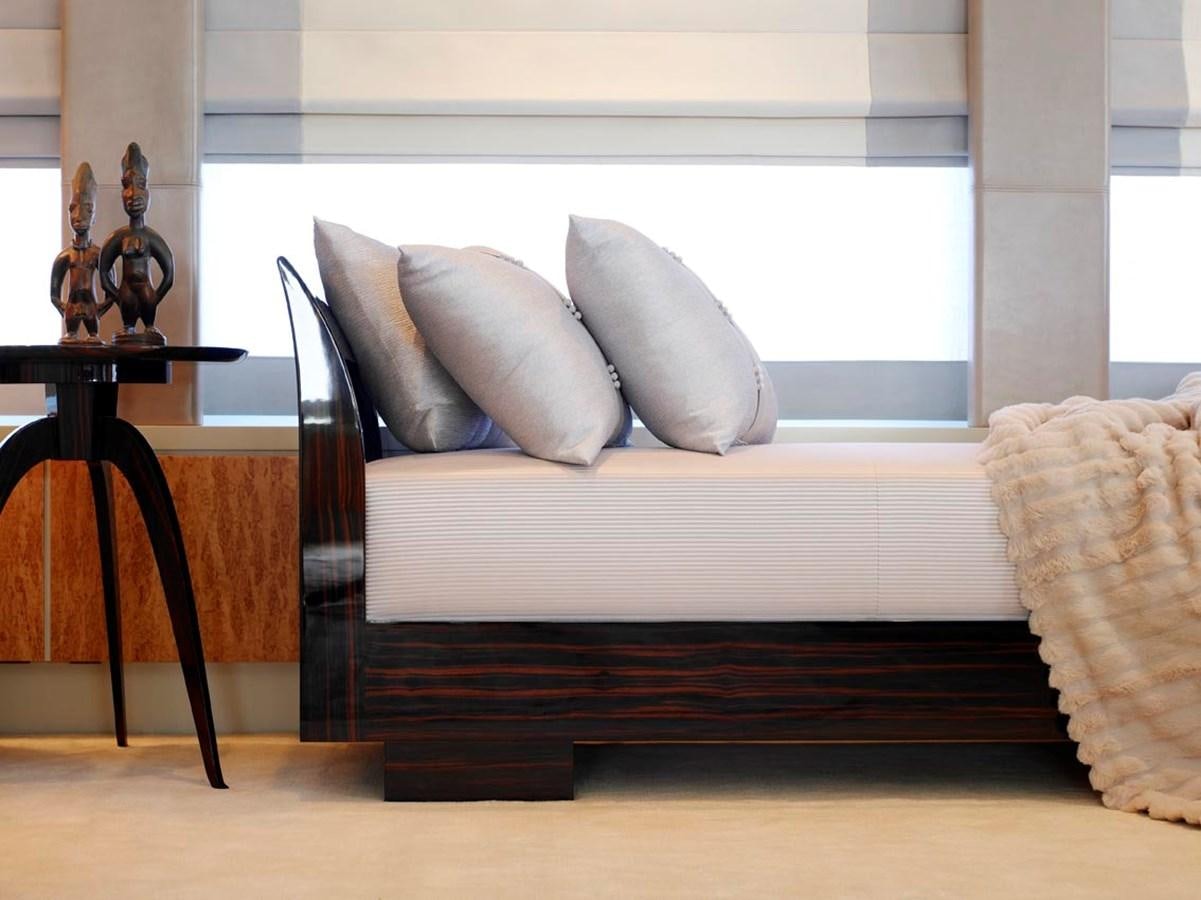 a white bed with a white pillow aboard PREDATOR Yacht for Sale