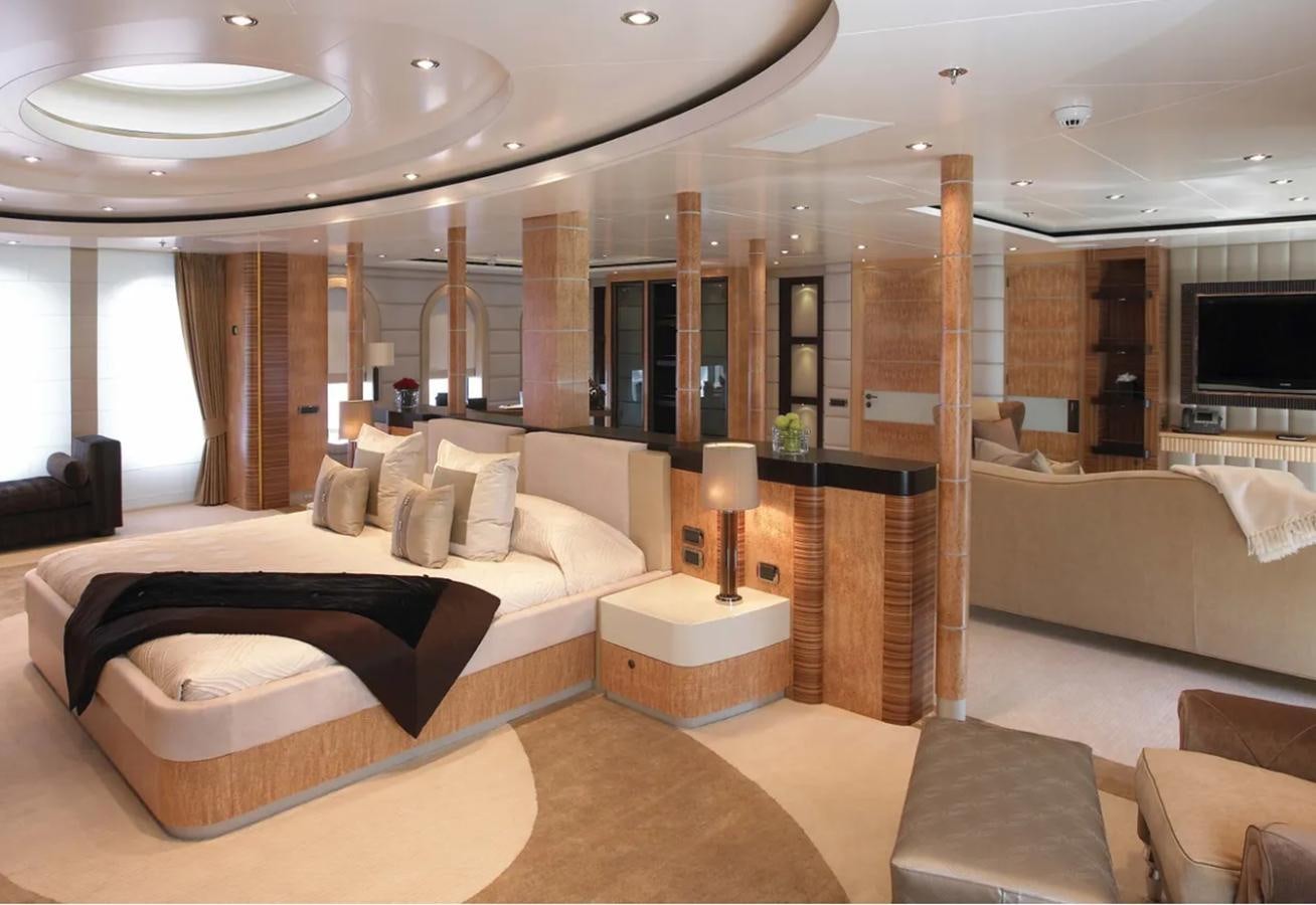 a large hotel room with a large bed and a large mirror aboard PREDATOR Yacht for Sale
