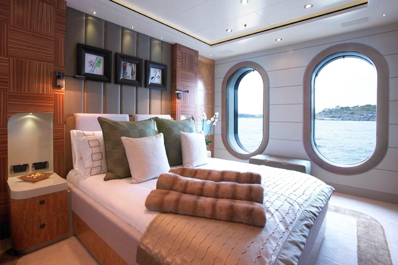 a bed with a large window aboard PREDATOR Yacht for Sale