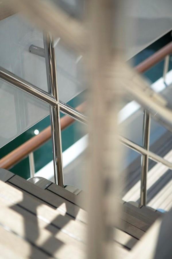 a close-up of a spiral staircase aboard PREDATOR Yacht for Sale