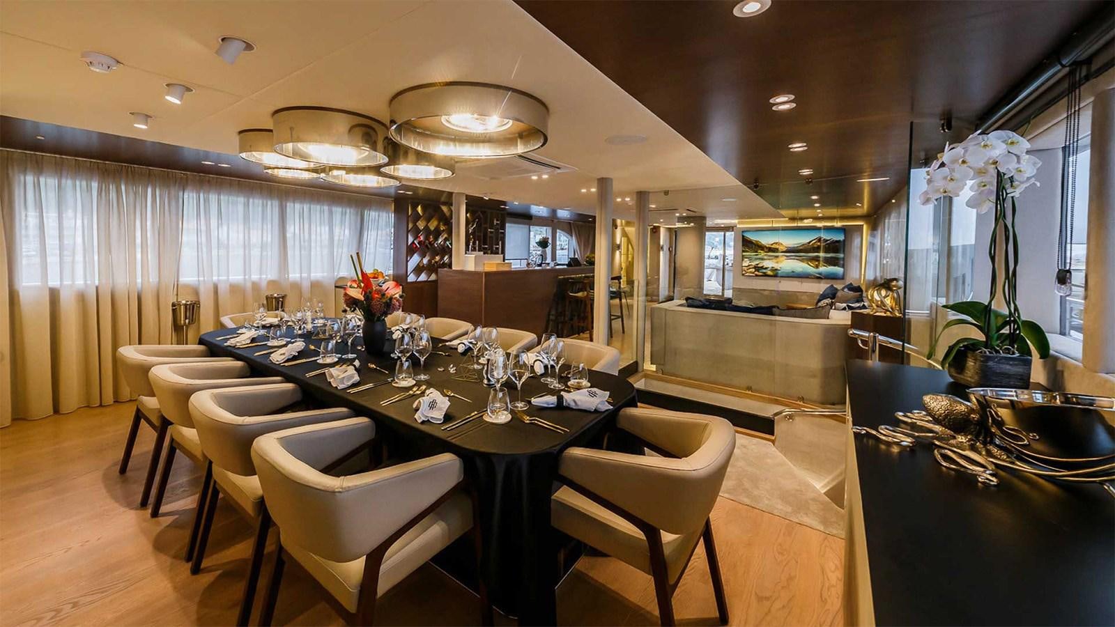 a large kitchen with a dining table aboard CLASE AZUL Yacht for Sale
