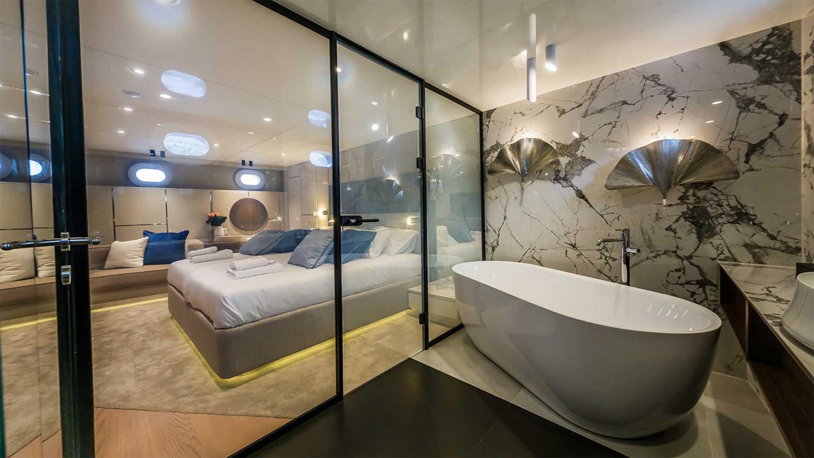 a bathroom with a tub and a bed aboard CLASE AZUL Yacht for Sale