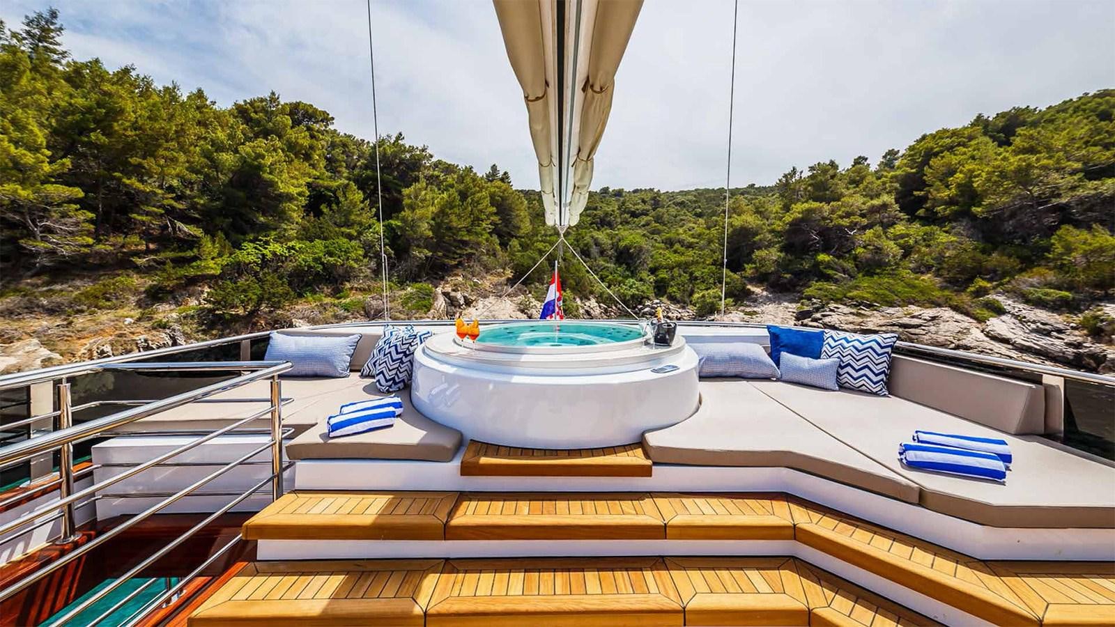 a deck with a pool and a boat on it aboard CLASE AZUL Yacht for Sale