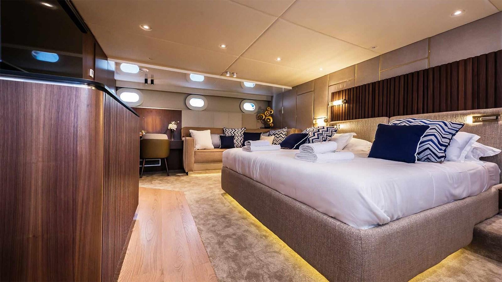 a room with a bed and a couch aboard CLASE AZUL Yacht for Sale