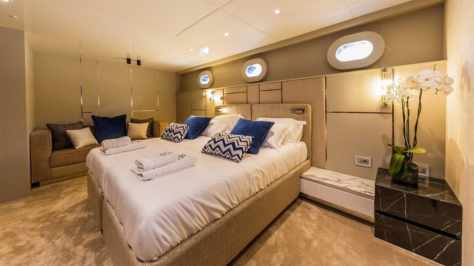 a room with a bed and a desk aboard CLASE AZUL Yacht for Sale