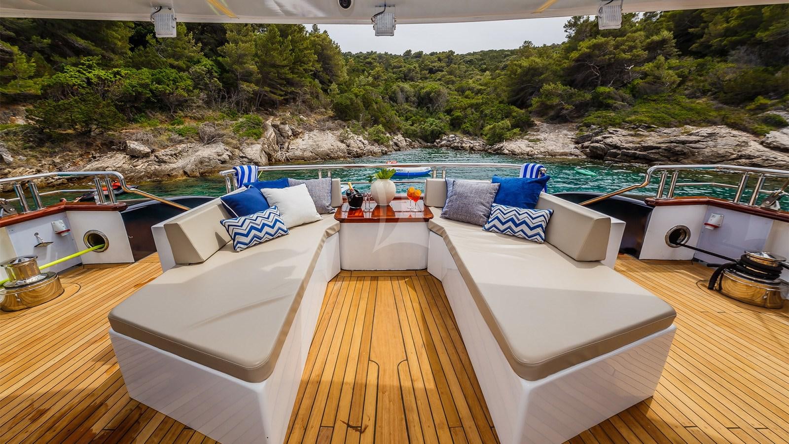 a deck with a pool and a deck with a view of a mountain range aboard CLASE AZUL Yacht for Sale
