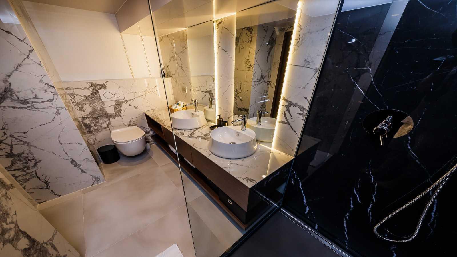 a bathroom with a large mirror aboard CLASE AZUL Yacht for Sale