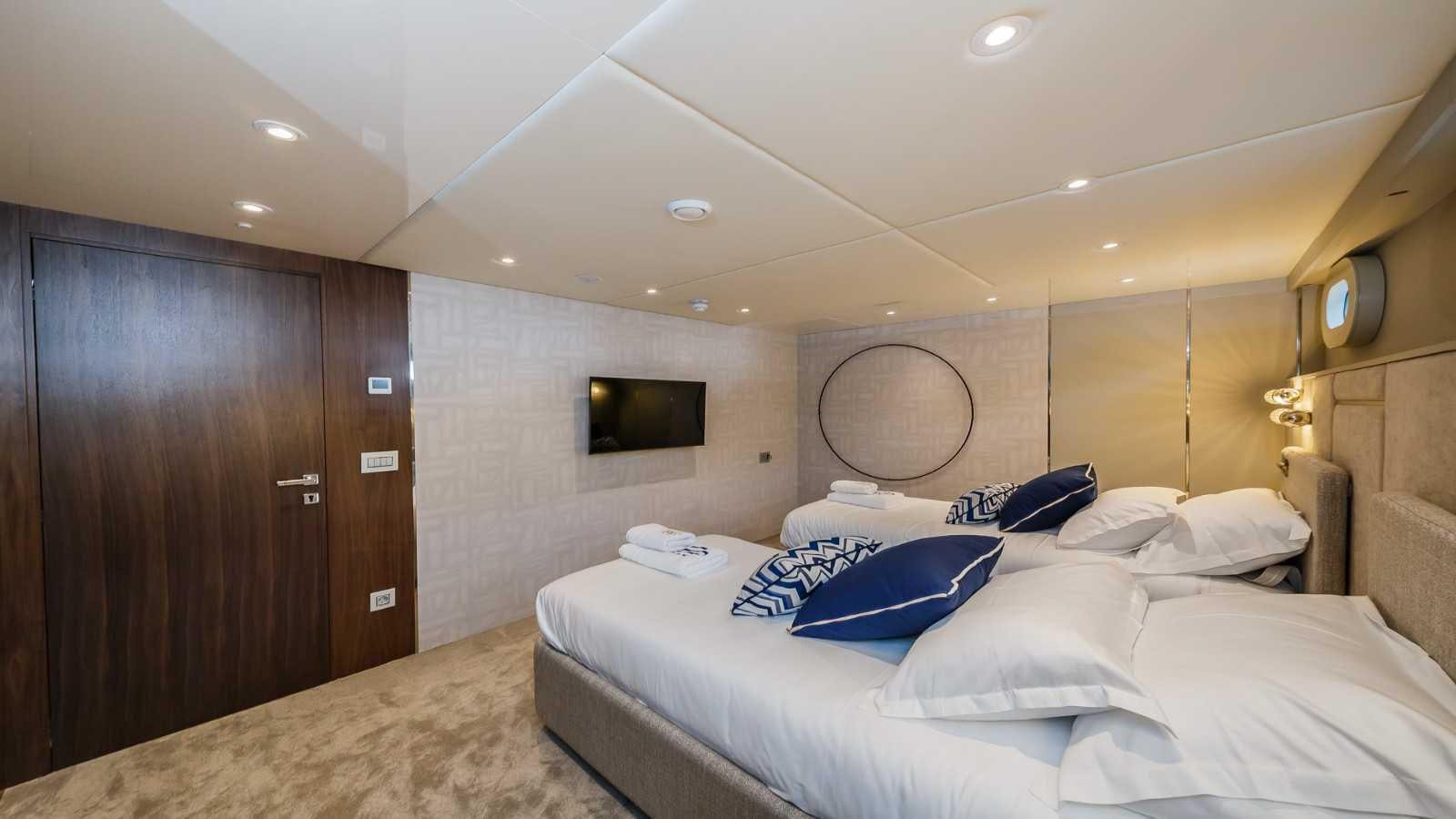 a room with a bed and a television aboard CLASE AZUL Yacht for Sale