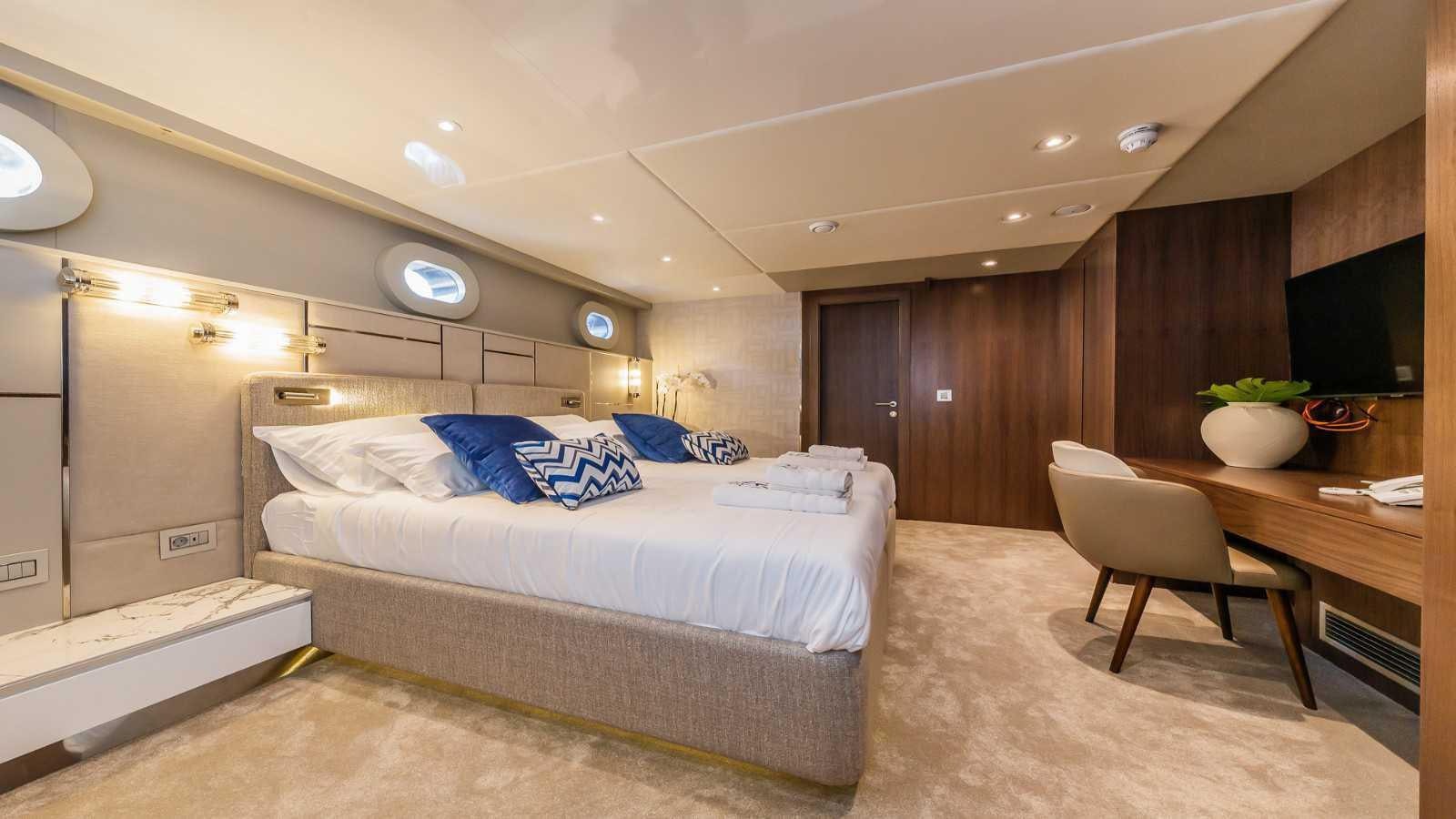 a room with a bed and a chair aboard CLASE AZUL Yacht for Sale