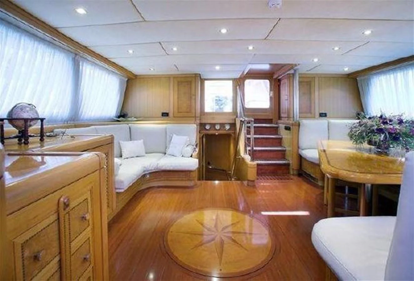 a large living room with a wood floor aboard ORIEL Yacht for Sale