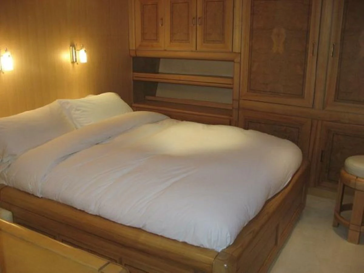 a bed with white sheets aboard ORIEL Yacht for Sale