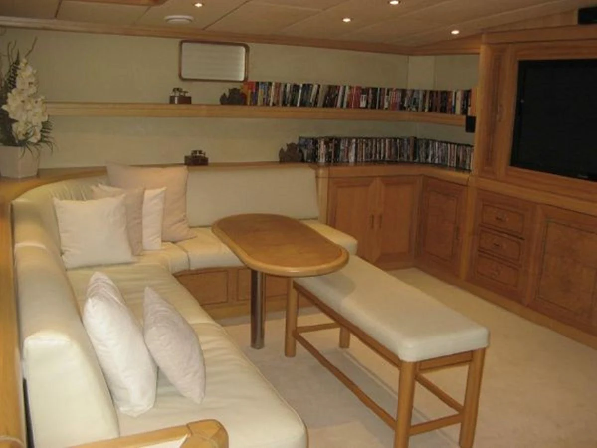 a living room with a couch and a coffee table aboard ORIEL Yacht for Sale