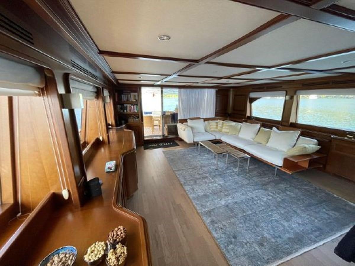 a living room with a large blue rug aboard STELLA MARIS Yacht for Sale