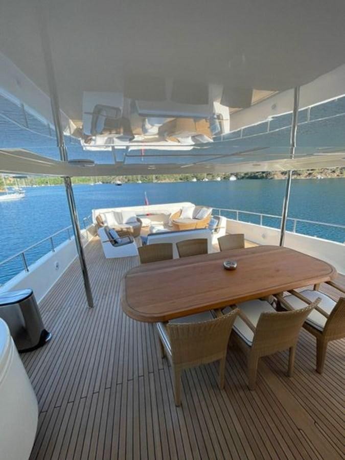 a table on a deck overlooking a body of water aboard STELLA MARIS Yacht for Sale