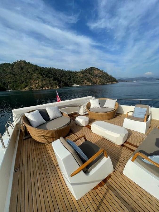 a deck with a view of the ocean and a beach aboard STELLA MARIS Yacht for Sale