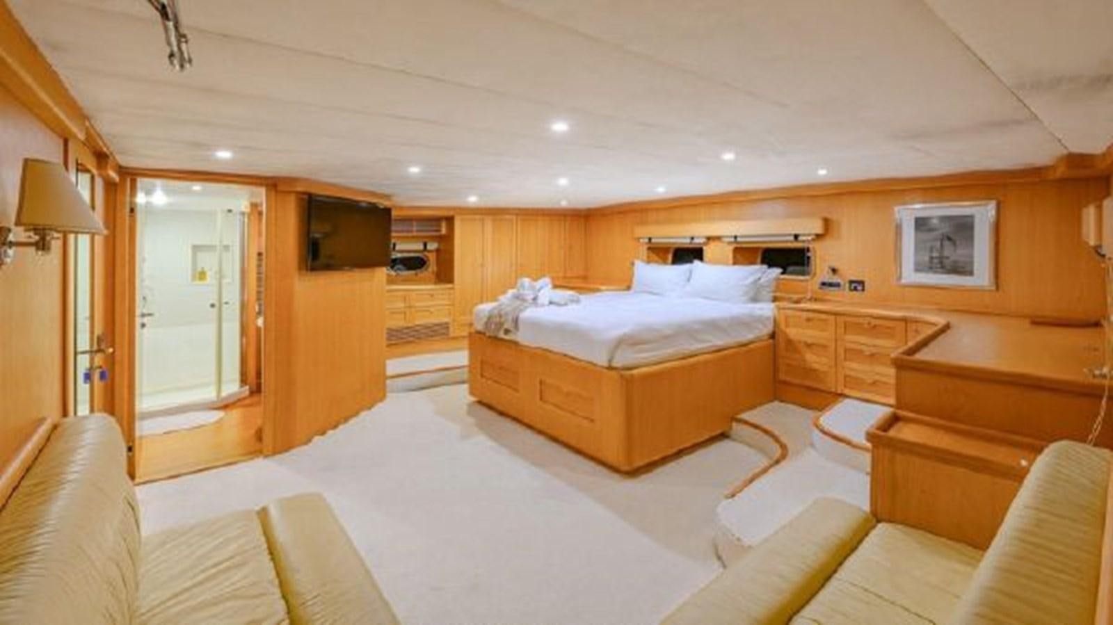 a bedroom with a bed and a couch aboard VIVA SHIRA Yacht for Sale