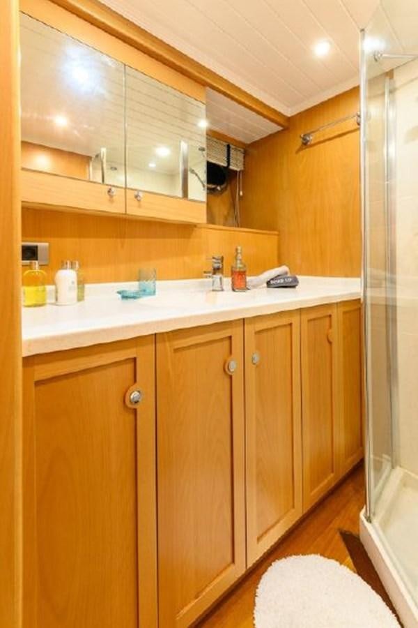 a kitchen with wooden cabinets aboard VIVA SHIRA Yacht for Sale