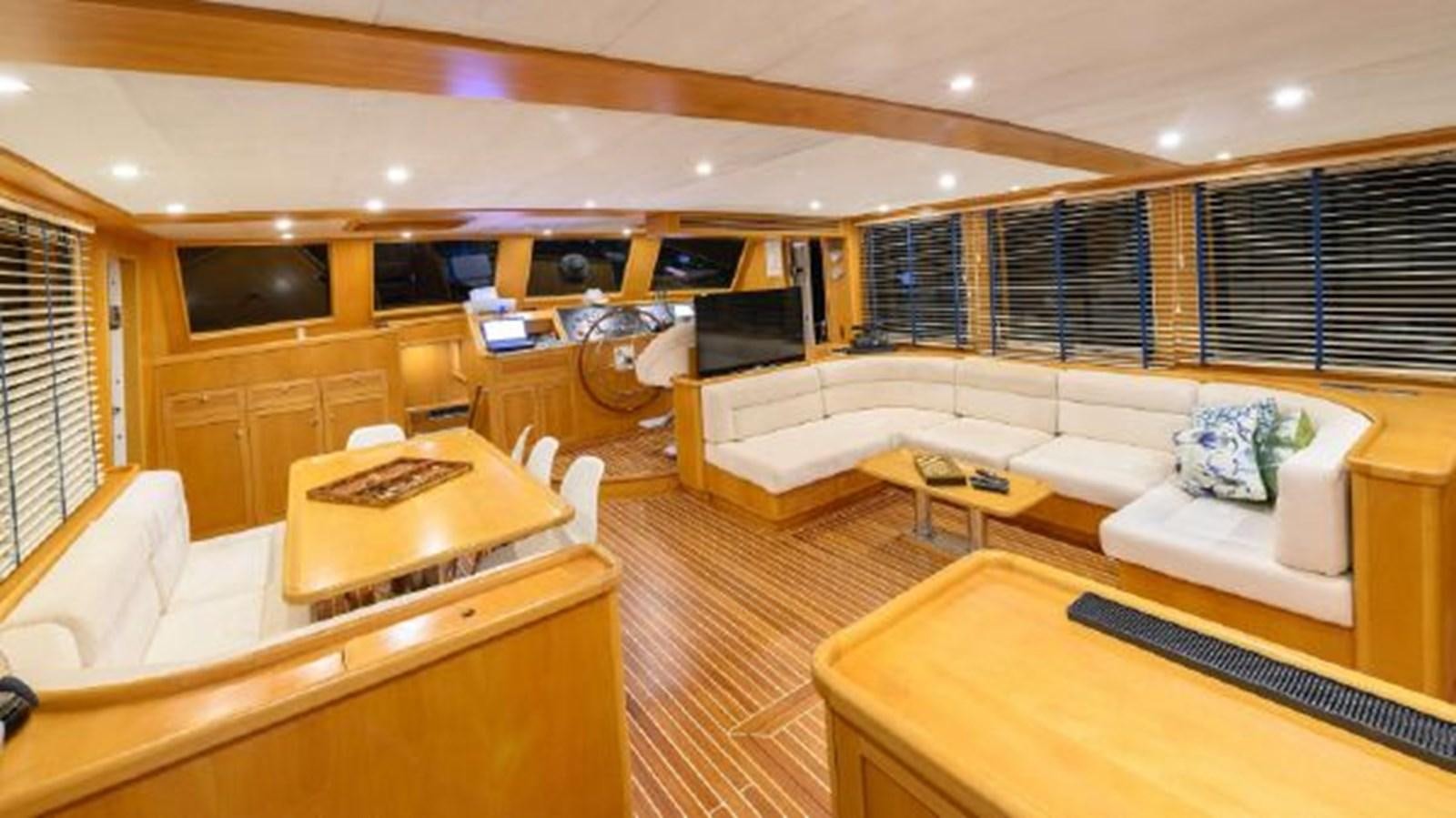 a room with a couch and a table aboard VIVA SHIRA Yacht for Sale