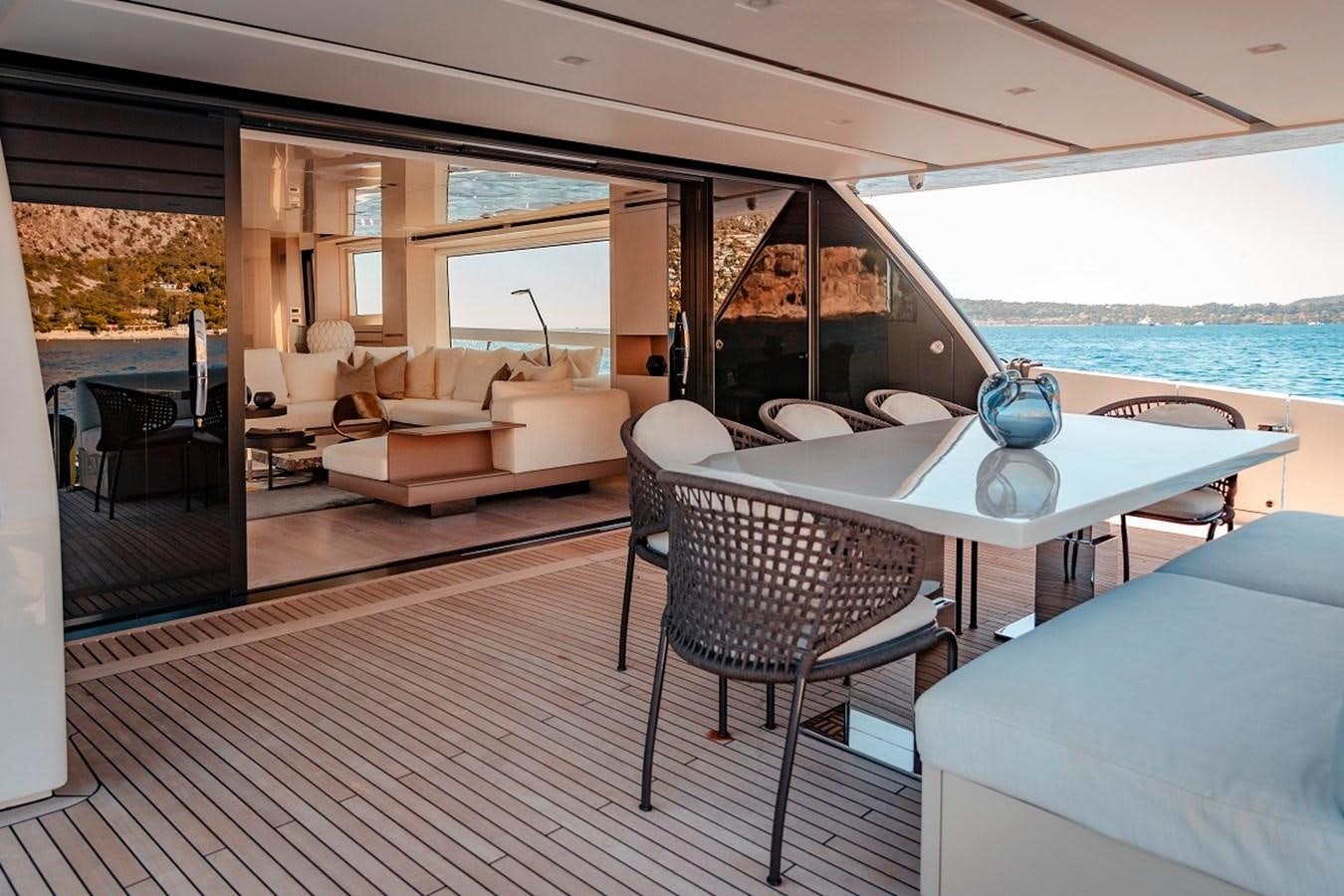 a living room with a table and chairs aboard LA SX88 Yacht for Sale
