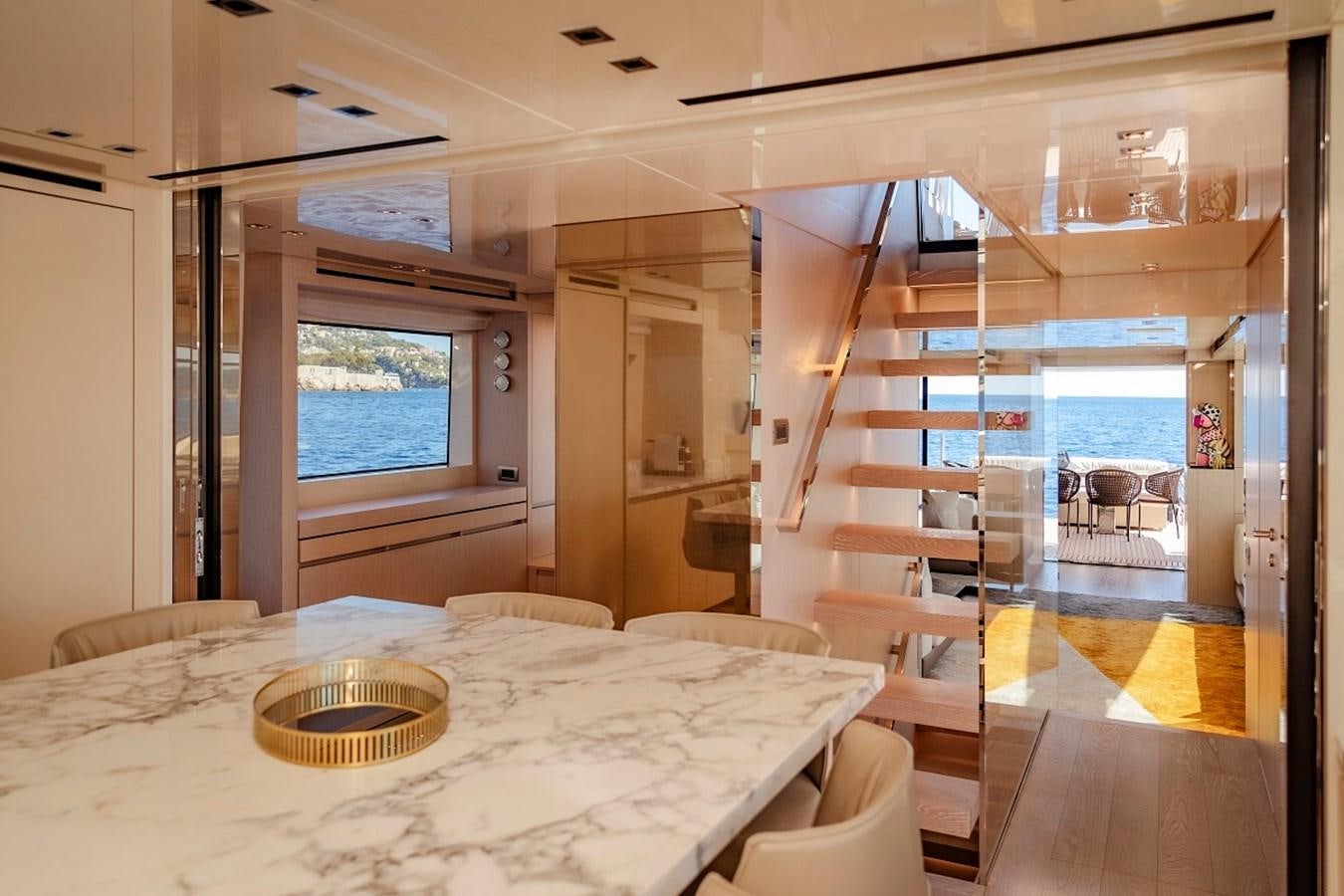 a room with a table and chairs aboard LA SX88 Yacht for Sale