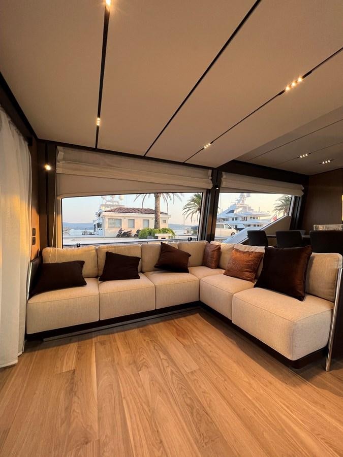 a living room with a large window aboard AISULU Yacht for Sale