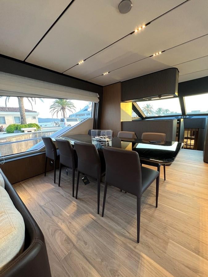 a room with a table and chairs aboard AISULU Yacht for Sale