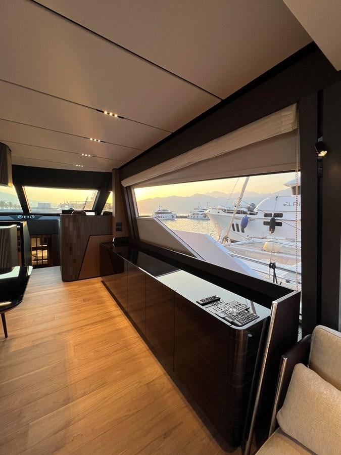 a room with a large window and a desk with a computer on it aboard AISULU Yacht for Sale