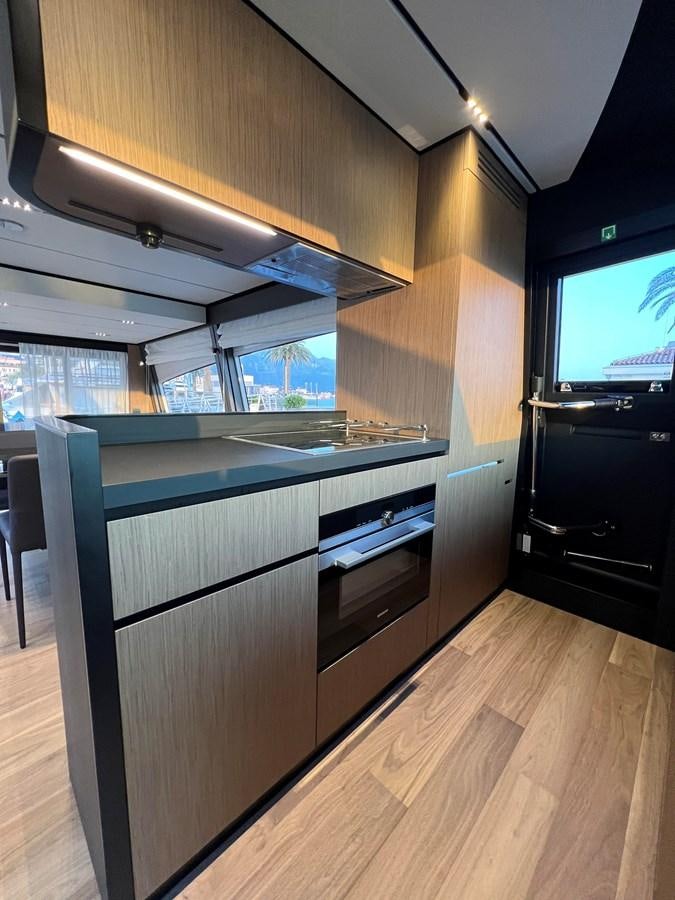 a kitchen with a large island aboard AISULU Yacht for Sale