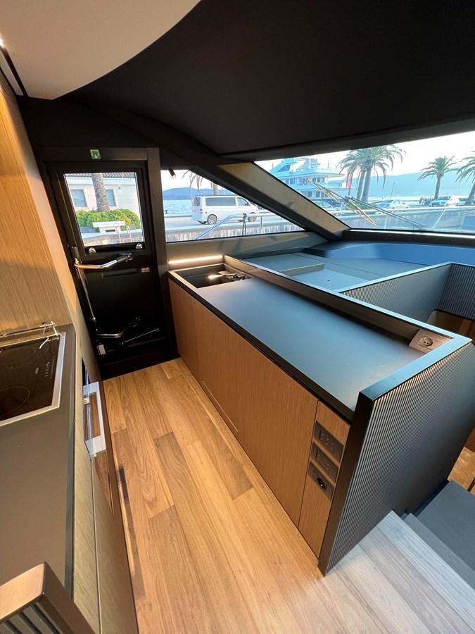 a room with a large window and a wood floor aboard AISULU Yacht for Sale