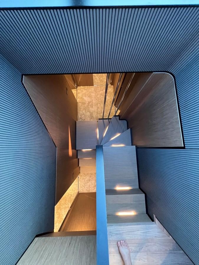 a blue and black staircase aboard AISULU Yacht for Sale