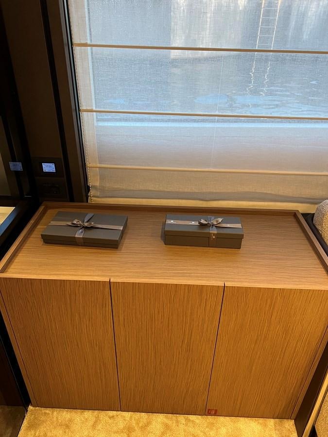 a video game console on a desk aboard AISULU Yacht for Sale