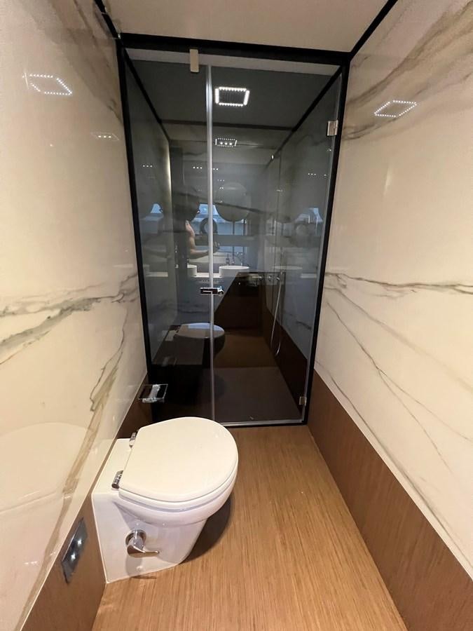 a bathroom with a glass shower aboard AISULU Yacht for Sale