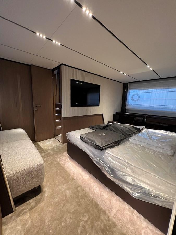 a bedroom with a tv on the wall aboard AISULU Yacht for Sale