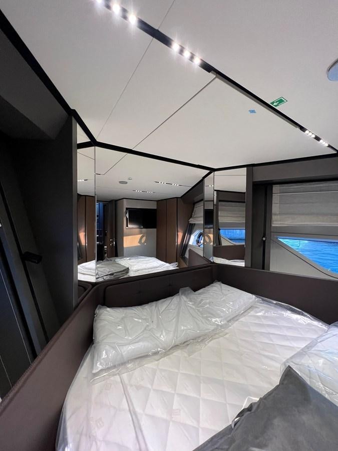 a room with a bed and a window aboard AISULU Yacht for Sale