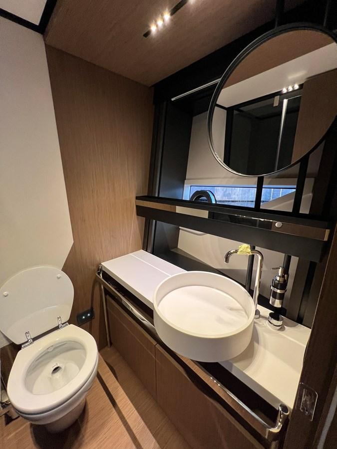 a bathroom with a sink and a toilet aboard AISULU Yacht for Sale