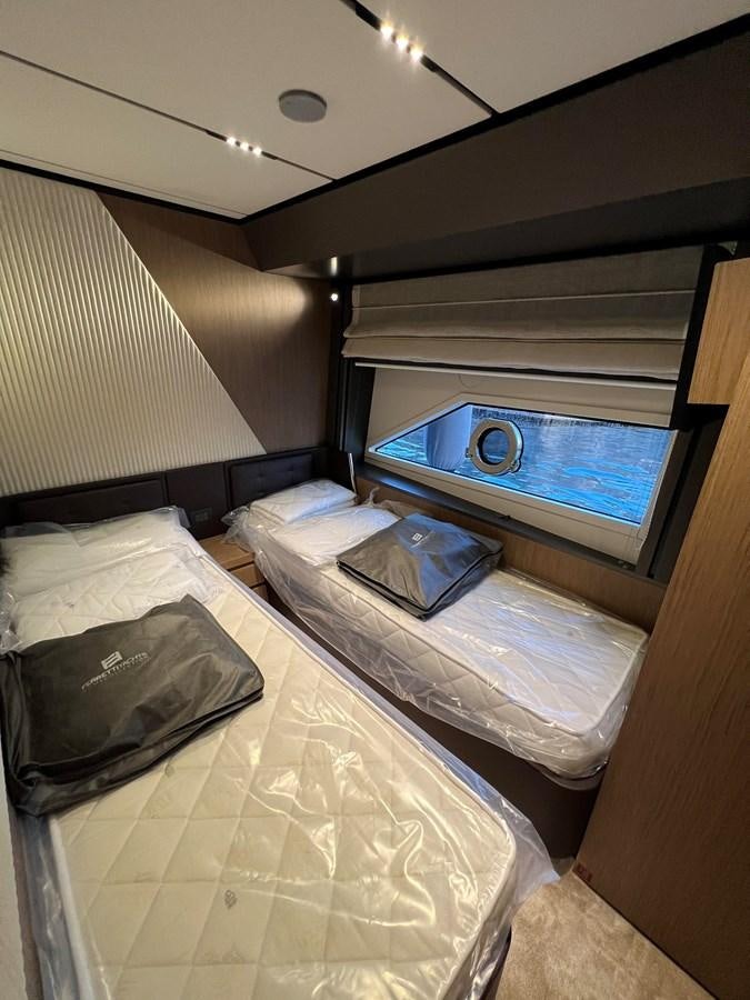 a small bed with a pillow on it aboard AISULU Yacht for Sale